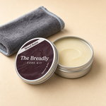 Open tin showing the pale solid wood balm inside
