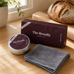 The Breadly Care Kit on a kitchen counter beside a sourdough loaf